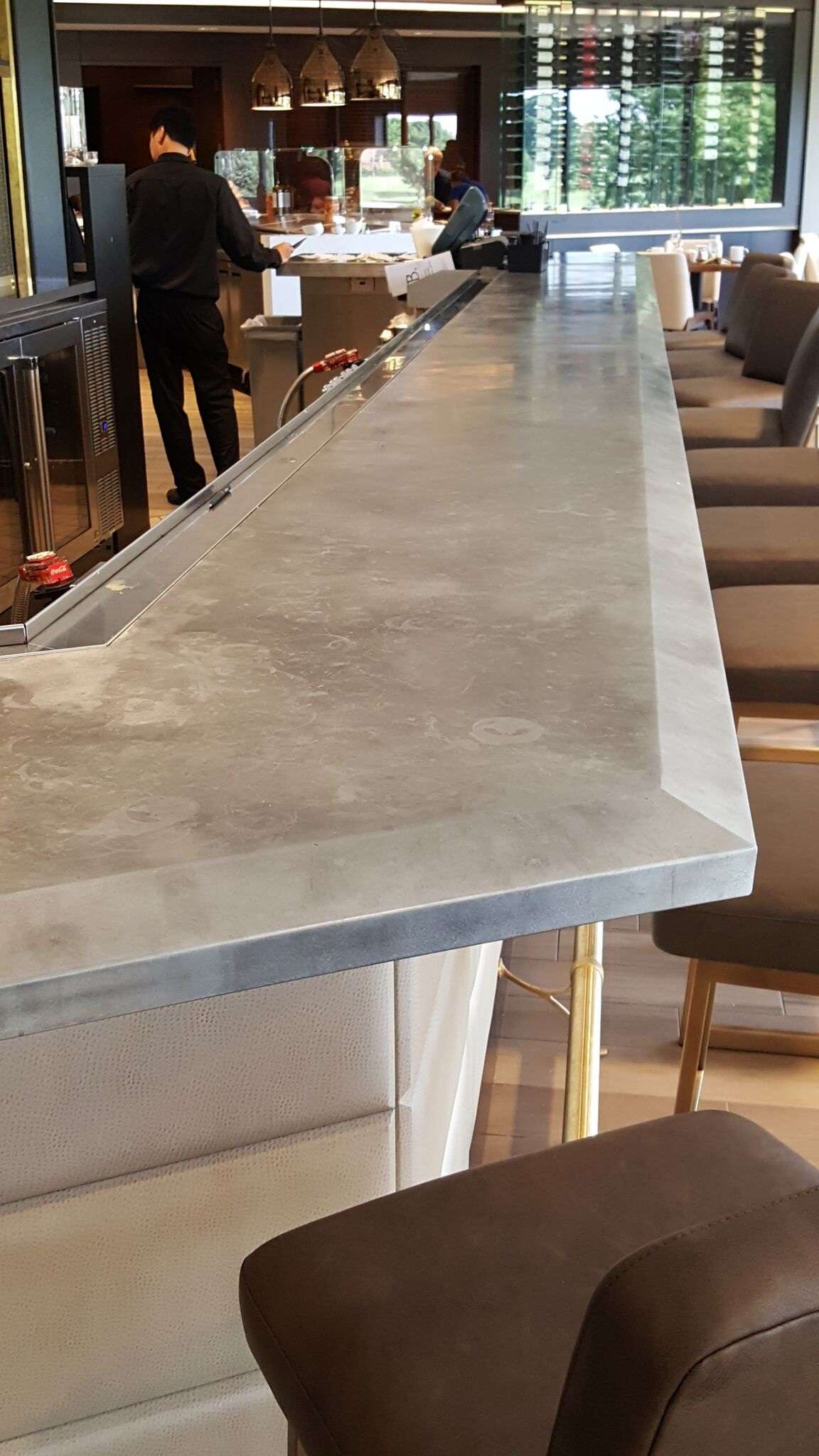 Zinc bar top with drink rail installed in a wet bar