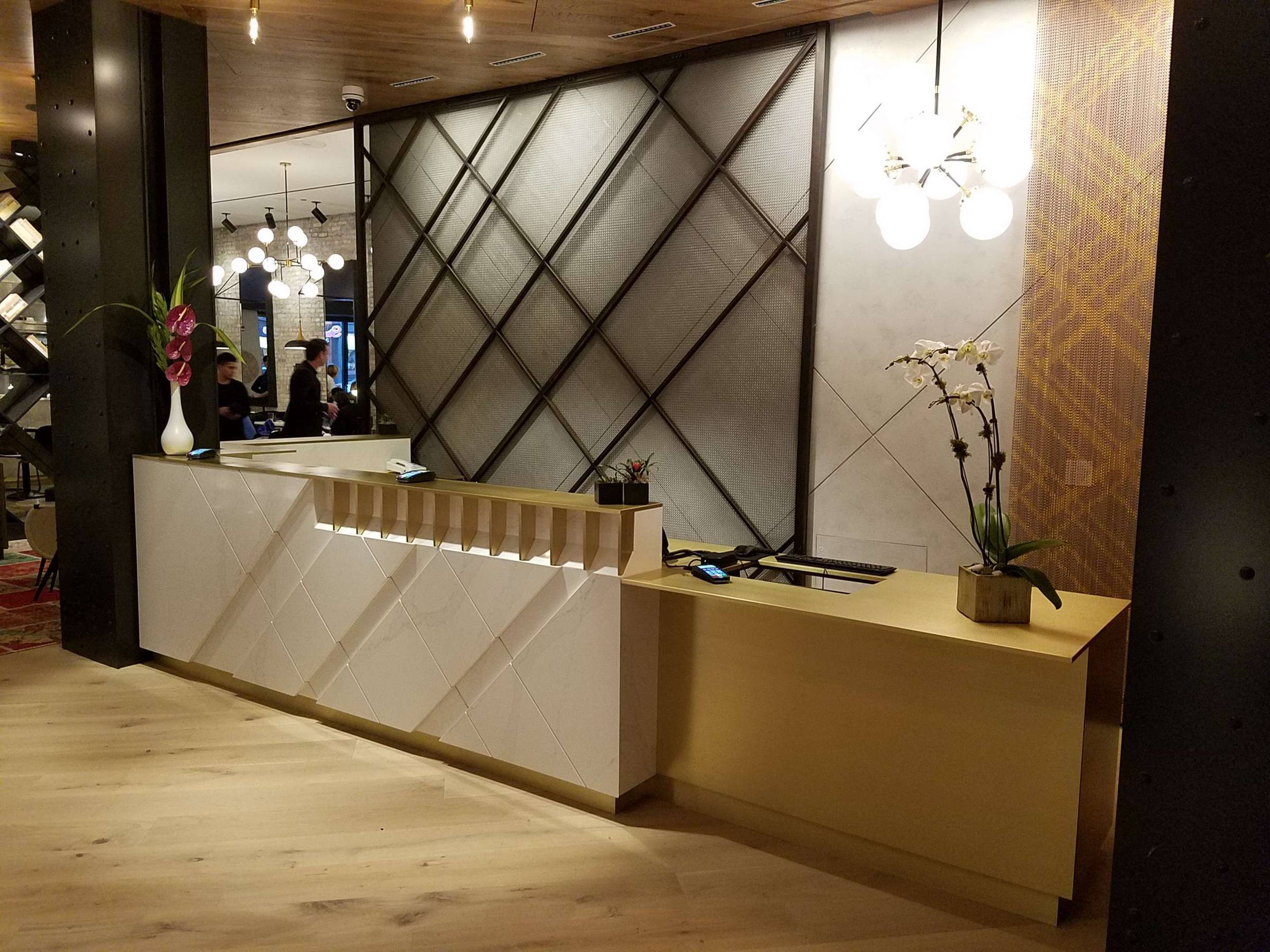 Brass countertop finished by hand in a residential kitchen, fabricated by Custom Metal Home
