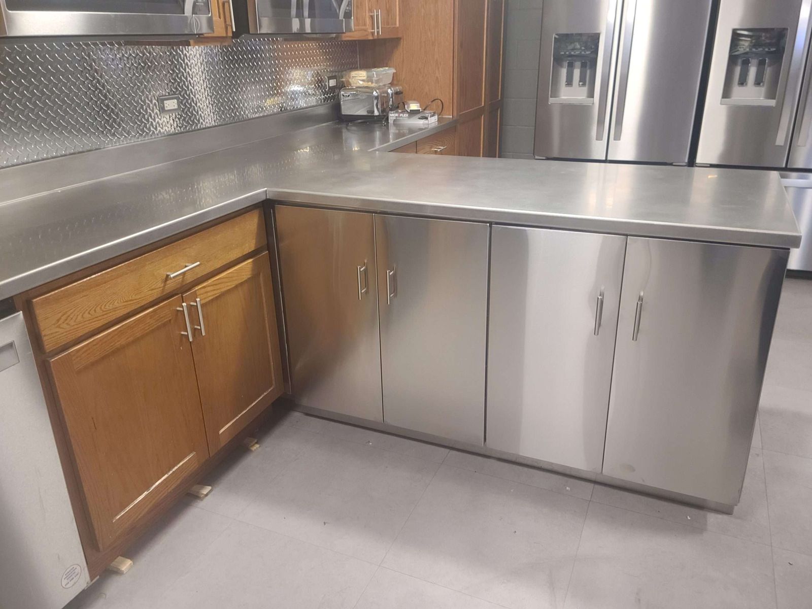 Stainless steel corner cabinets and countertop by Custom Metal Home
