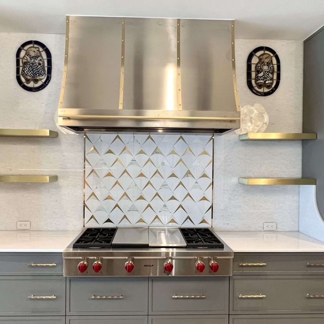 Brushed brass floating shelves beside a range hood, Custom Metal Home