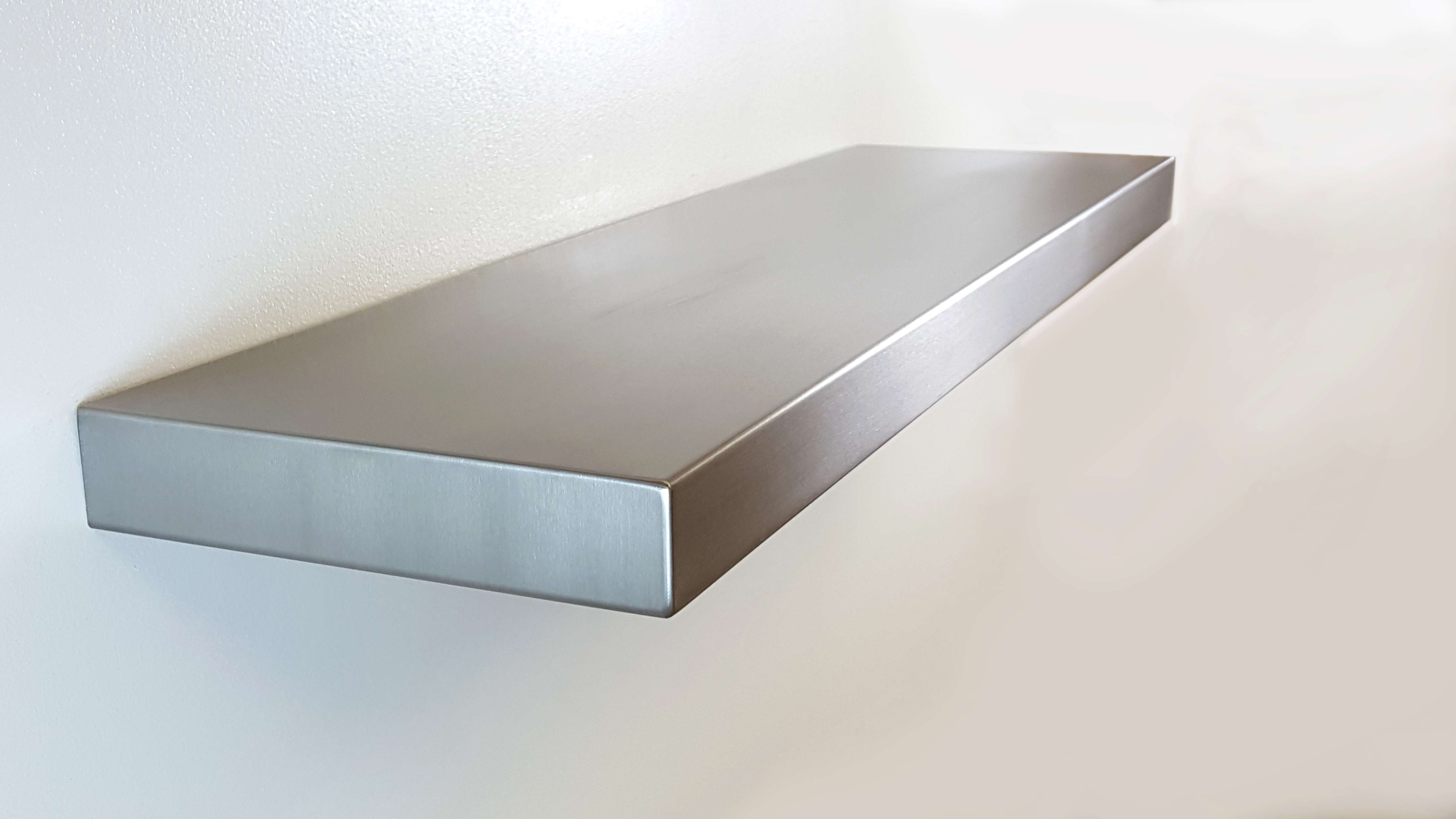 Seamless stainless steel floating shelf with no visible hardware, by Custom Metal Home