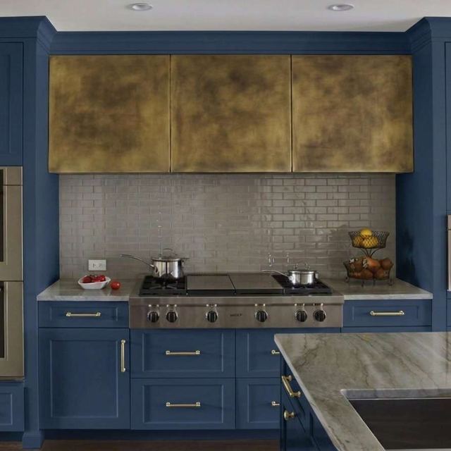 Brass box hood with a light patina finish in a navy kitchen, by Custom Metal Home