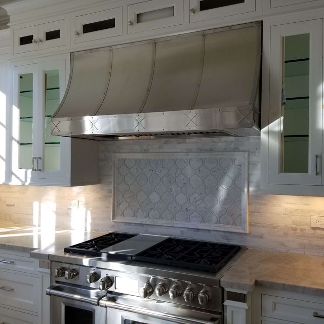 Custom Metal Home range hood. RH-1. Body: Stainless steel brushed finish. Straps: Stainless steel brushed finish with X pattern