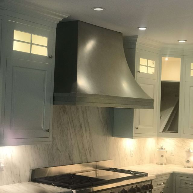 Custom Metal Home range hood. RH-5. Body: Stainless steel with matte finish. Bottom banding: Stainless steel with matte finish