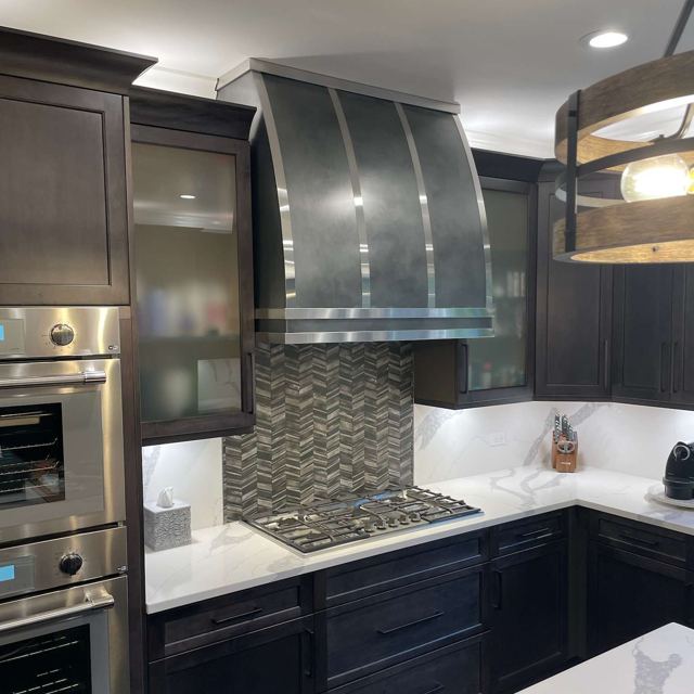 Custom Metal Home range hood. RH-2. Body: Zinc with dark patina. Straps: Stainless steel with brushed finish