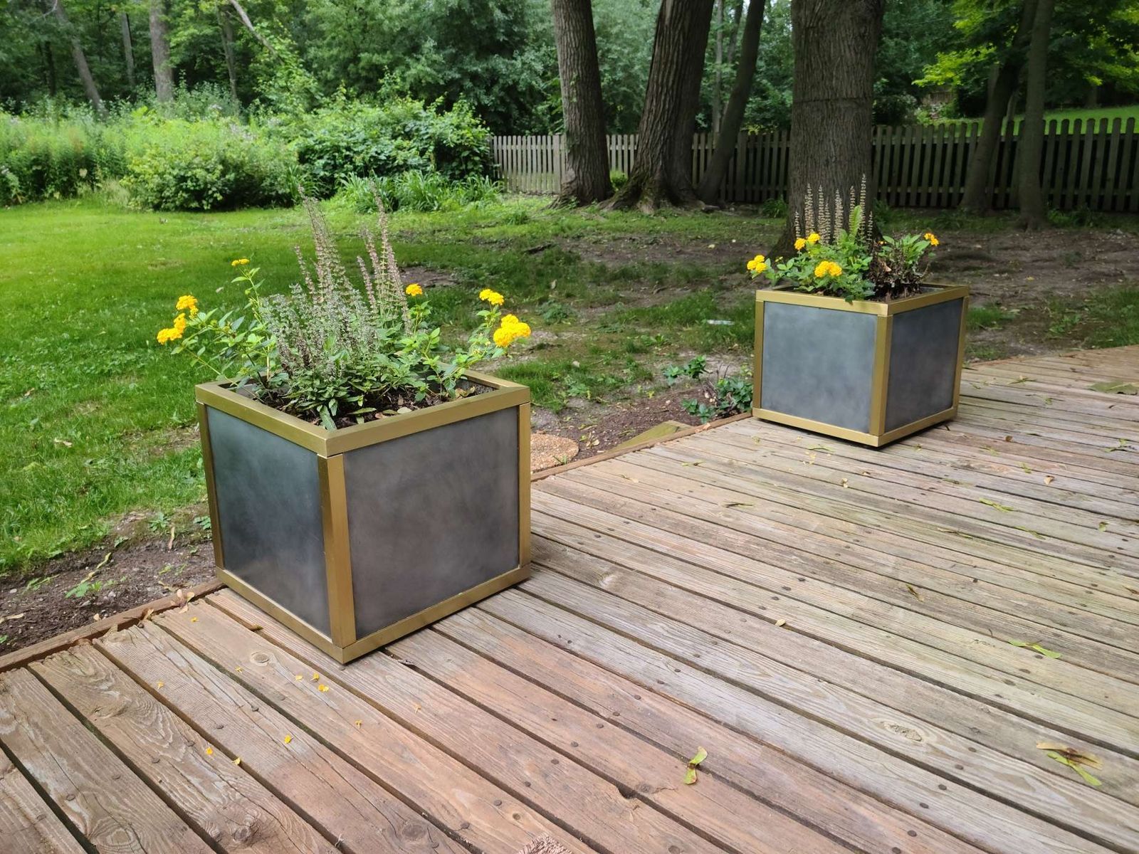 Zinc planters with brass trim on a deck by Custom Metal Home