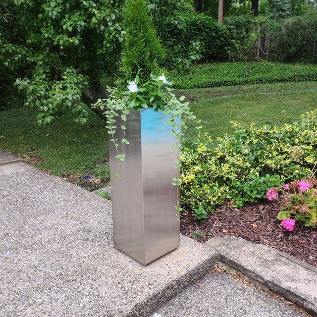 Tall stainless steel planter in a garden, Custom Metal Home