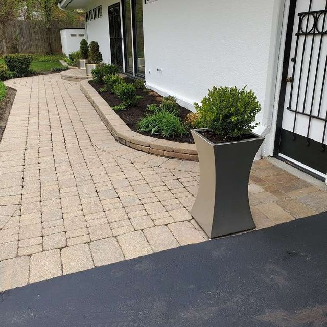 Curved stainless steel planter by a walkway, Custom Metal Home