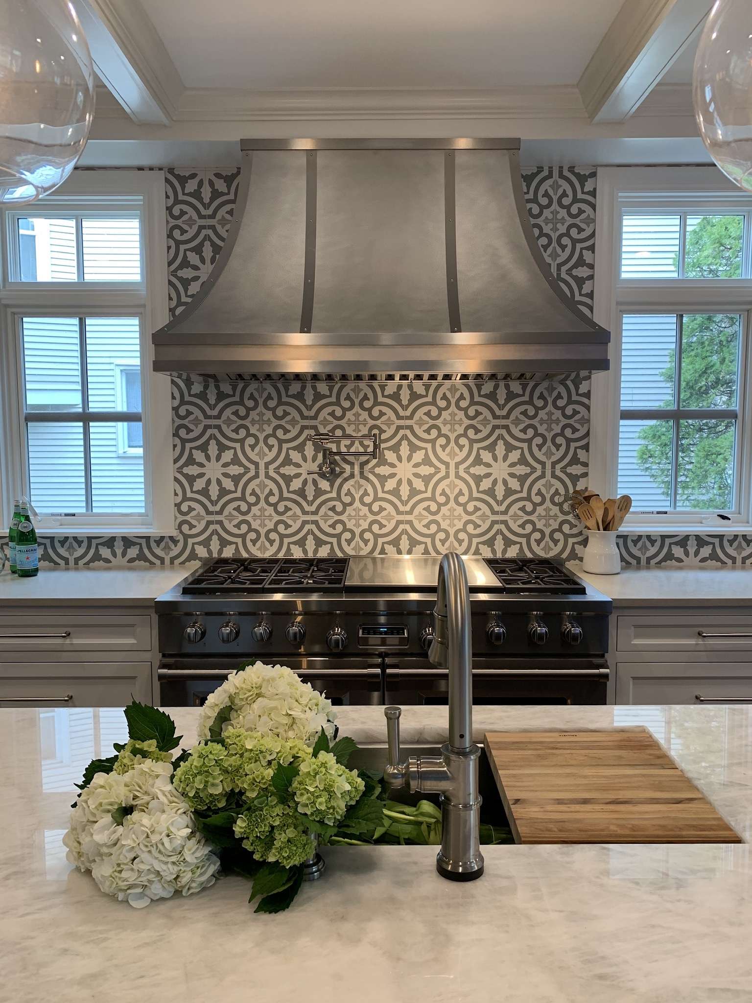 RH-5 stainless steel matte range hood in a residential kitchen