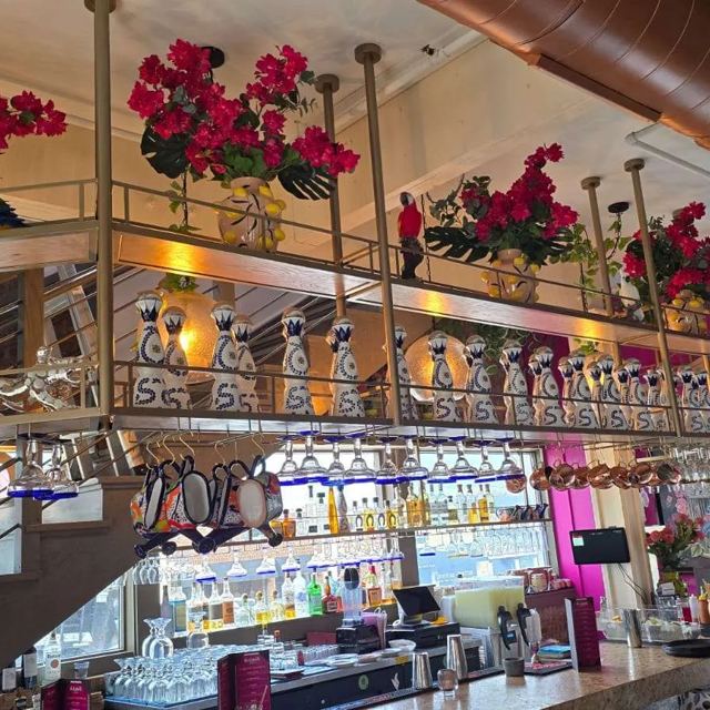 Suspended brass shelving over a restaurant bar, Custom Metal Home