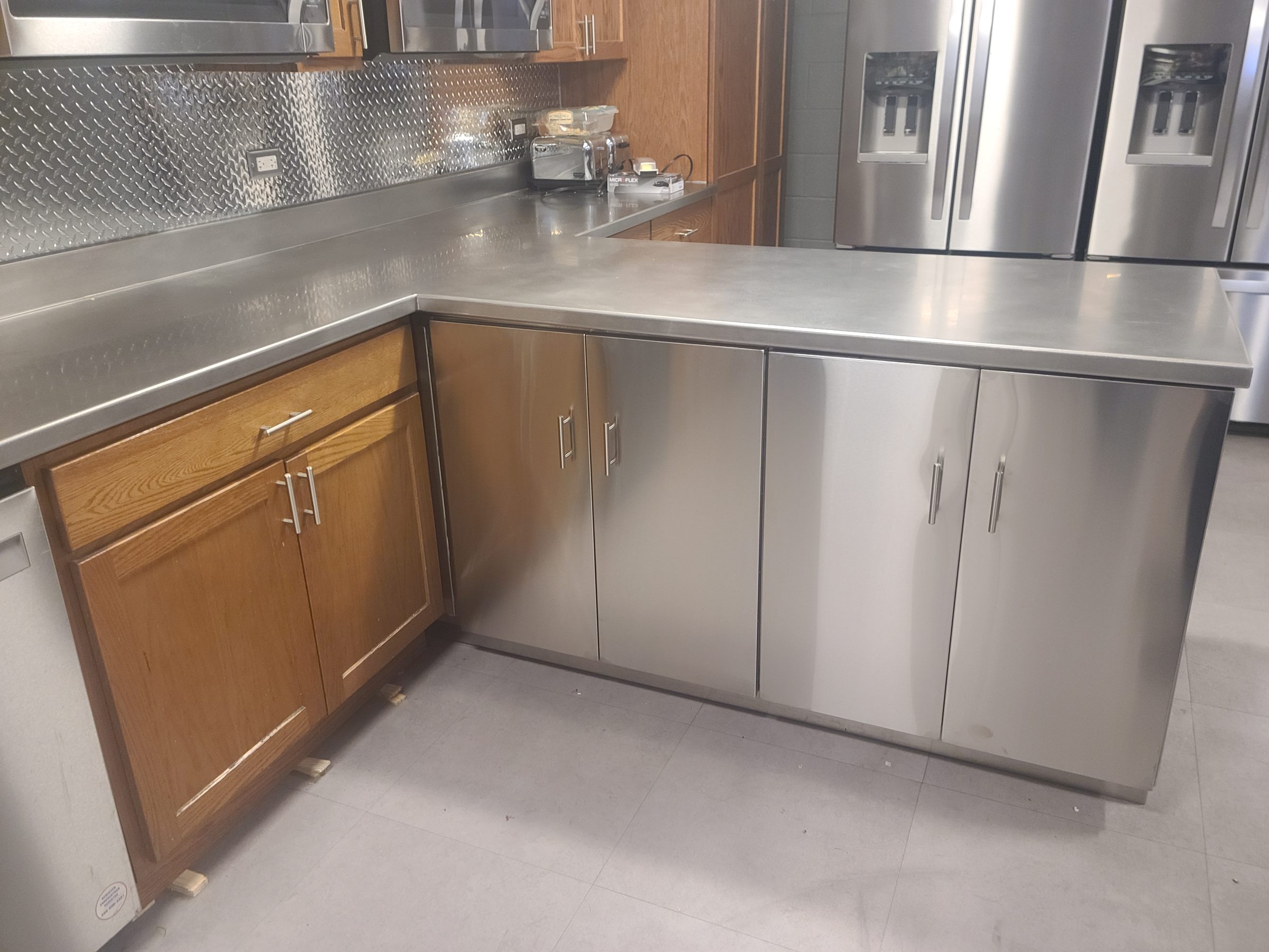 Stainless steel cabinets and countertop in a kitchen fabricated by Custom Metal Home