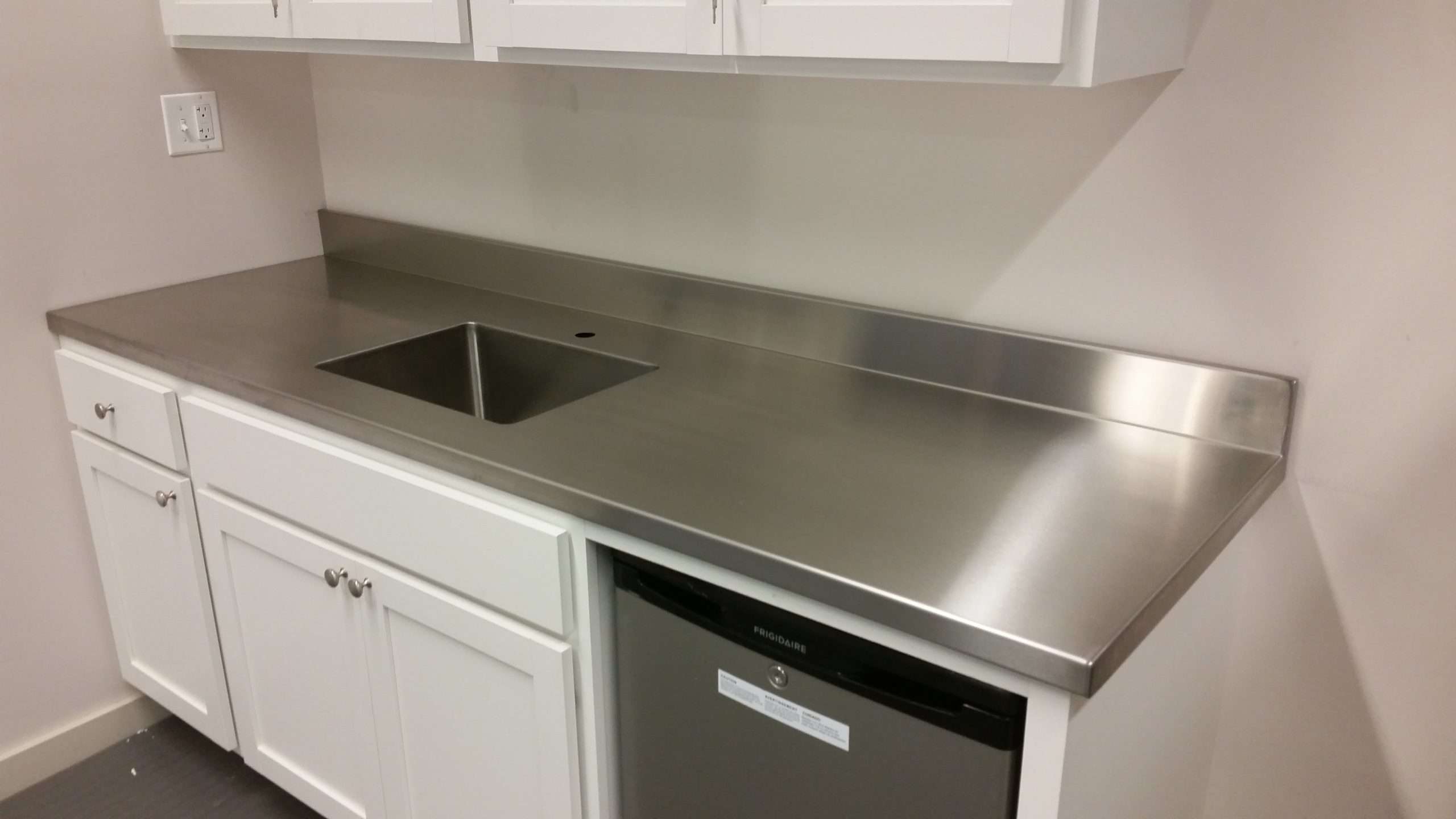 Stainless steel countertop in a residential kitchen fabricated by Custom Metal Home