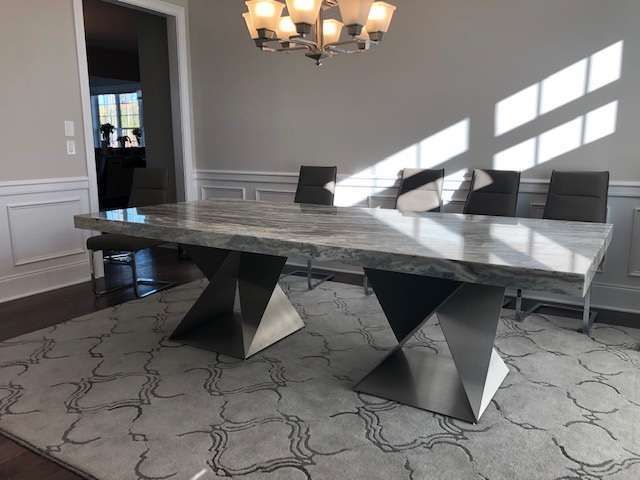Pair of Twist bases under a stone dining top