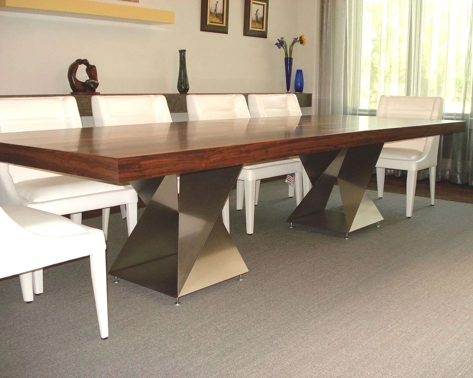 Walnut dining table on two stainless steel CMH Twist Bases, fabricated by Custom Metal Home