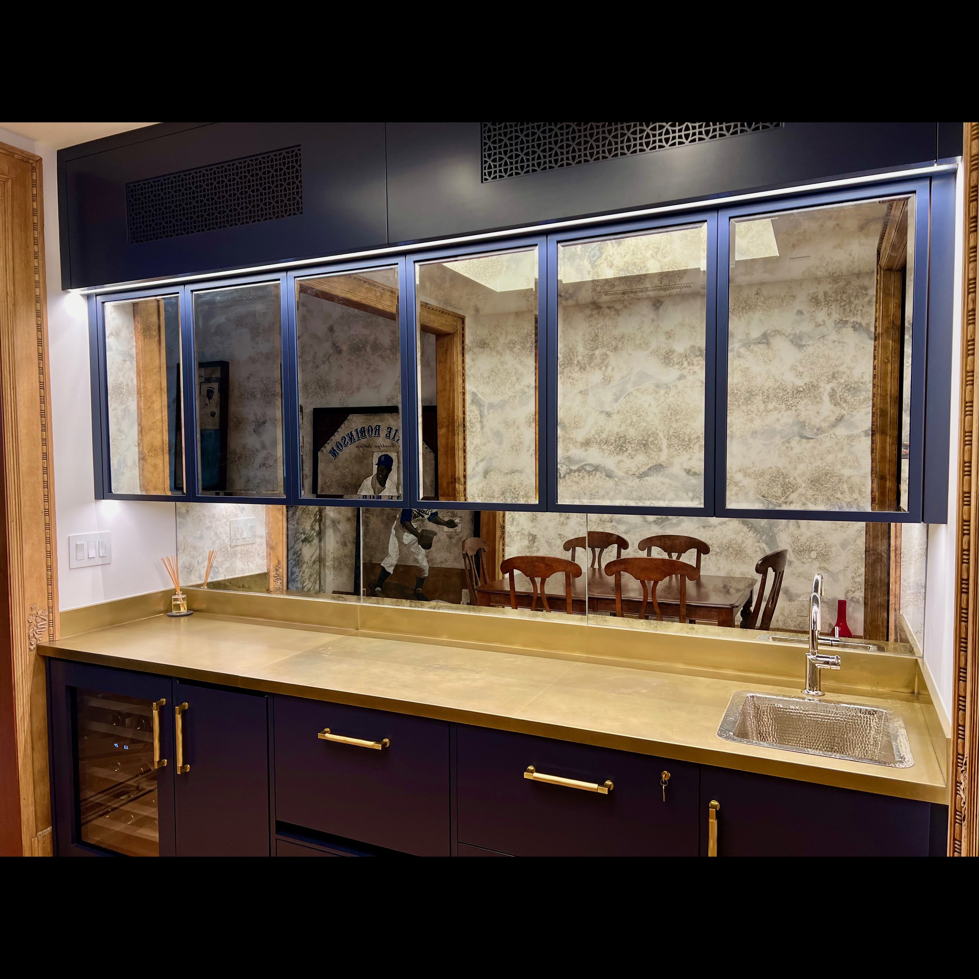 Brass countertop-integrated backsplash- light patina finish